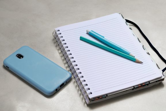 Blue pen on white notebook